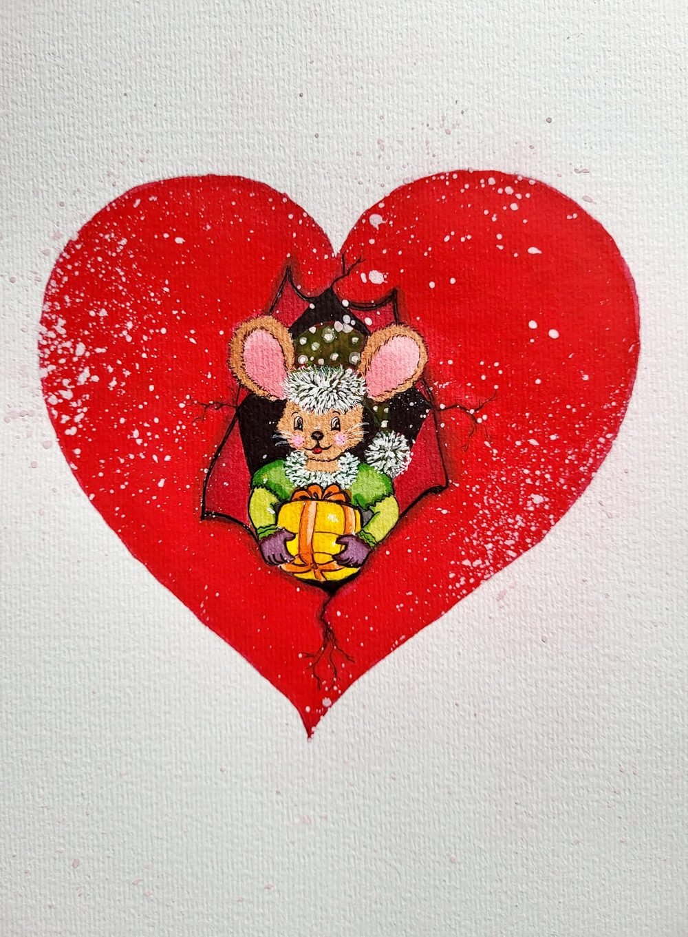 A little mouse tucked inside a big red heart