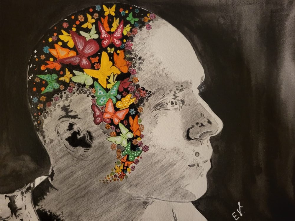 Profile portrait formed from autumn leaves and butterflies