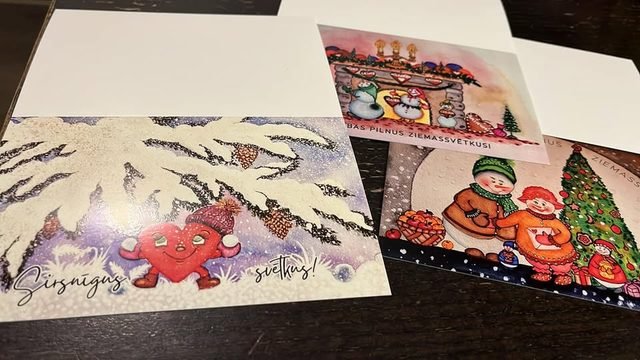 Three of Elina's Christmas cards laid out on a table