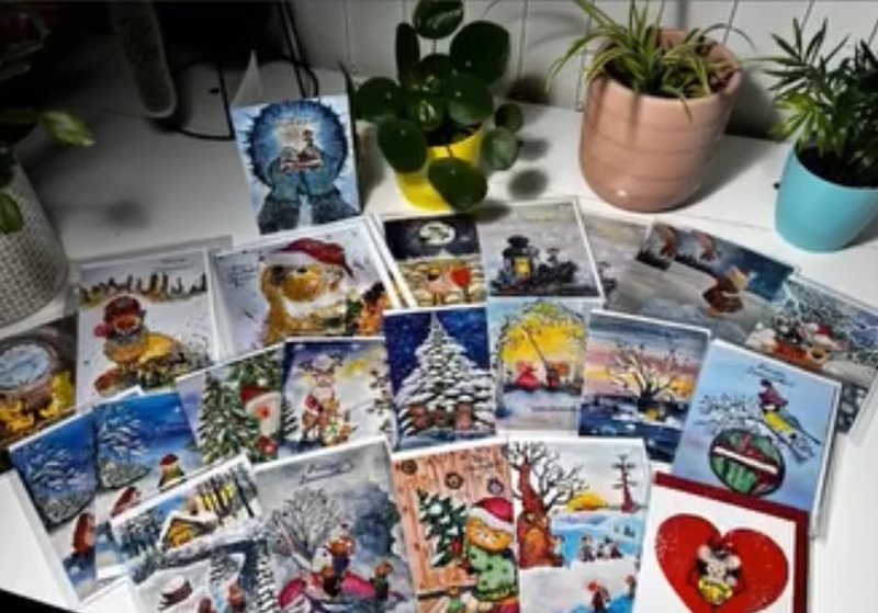 A joyful spread of Elina's Christmas cards on a desk